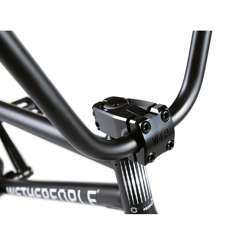 Close-up of the black handlebar and "WTP" engraved stem on a Wethepeople Crysis 20 Inch BMX Bike, showing part of the SaltPlus-equipped frame and branding.
