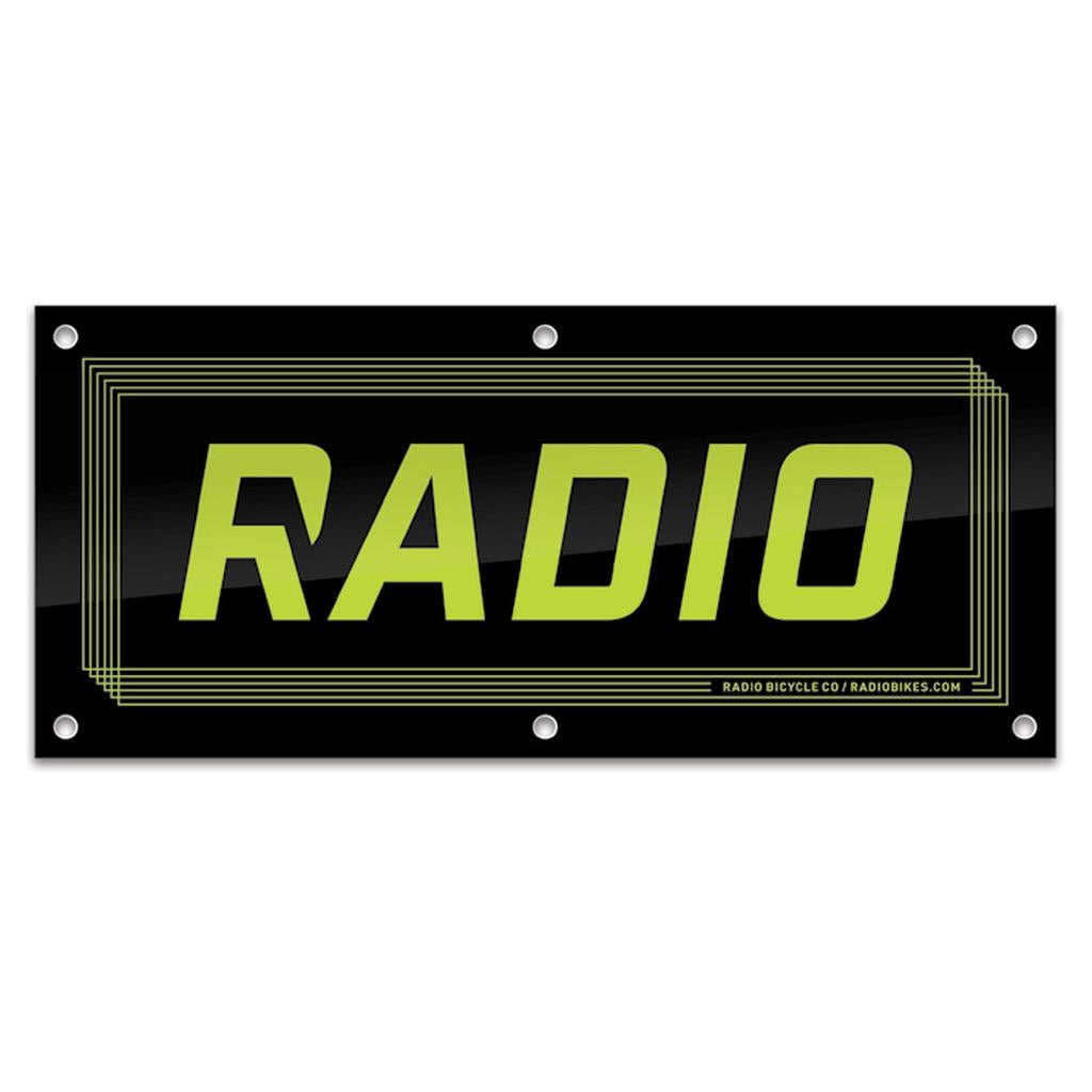 The Radio Shop Banner features "RADIO" in bold yellow-green letters on a black rectangular background with a thin geometric border—ideal for shop displays or as an eye-catching banner for event decor.