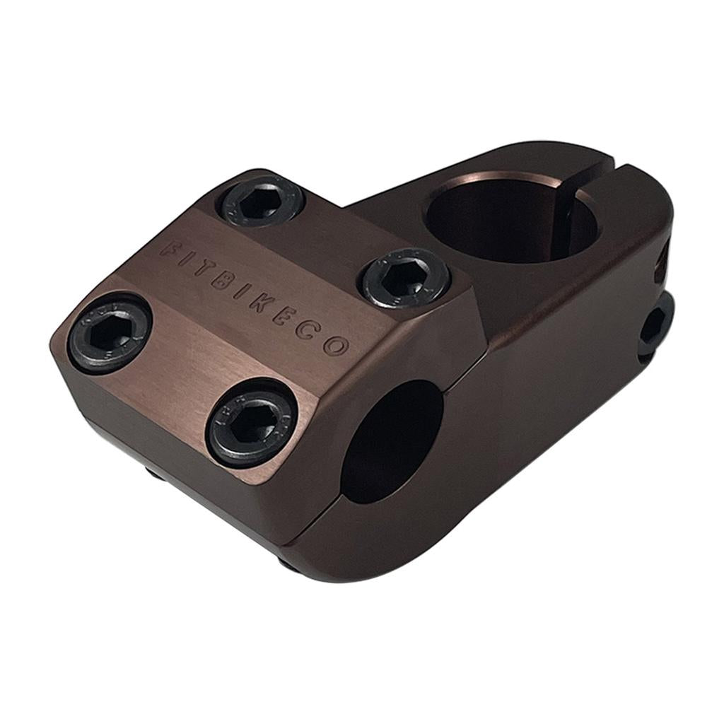 The Fit Aitken Top Load Stem is a brown metal BMX stem with four front-facing hex bolts and “FITBIKECO” engraved on top, designed as a limited edition inspired by the Mike Aitken signature series.