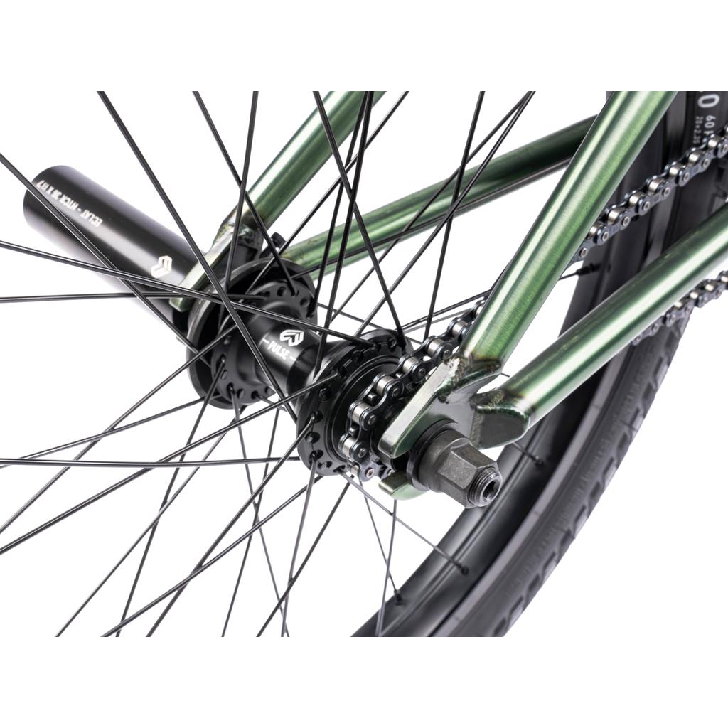 Close-up of a bicycle rear wheel showing the axle, chain, spokes, tire, and a black stunt peg—featuring quality aftermarket parts inspired by the Wethepeople Revolver 20 Inch Bike.