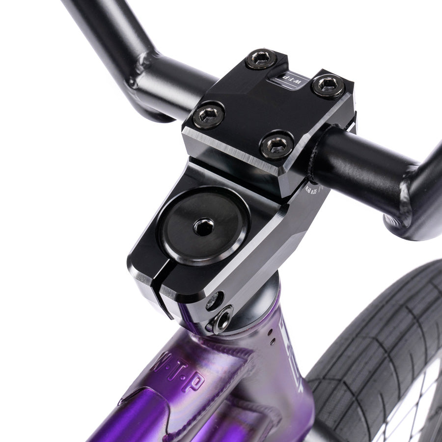 A close up of the handlebar on a Wethepeople Trust 20 Inch Freecoaster Bike, a purple BMX bike.