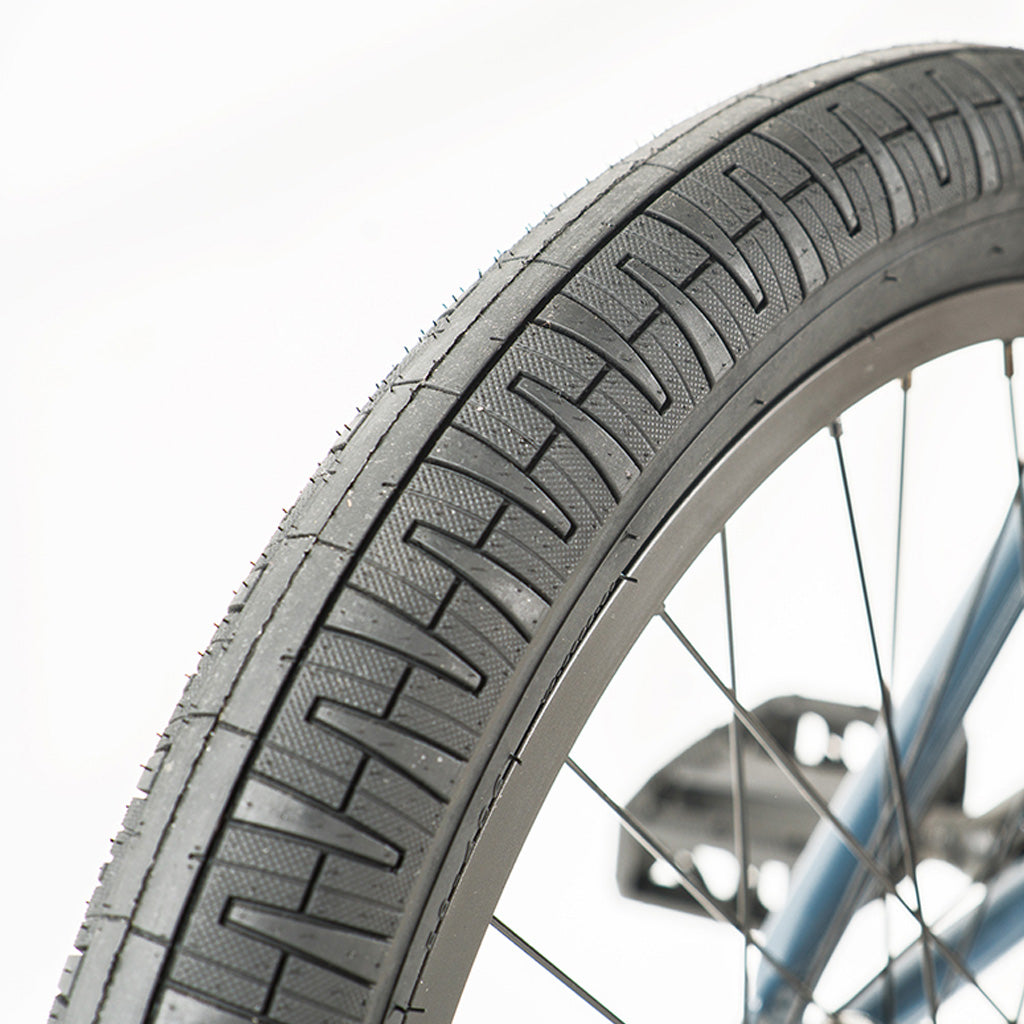 A close up of a Division Reark 20 Inch Bike tire on a white background.