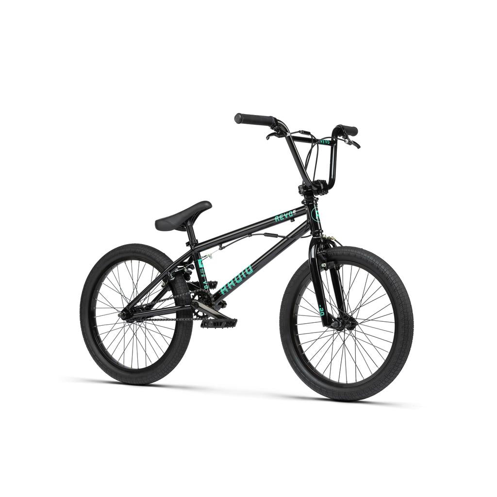 The Radio Revo Pro FS 20 Inch Bike is a black BMX with a 20" top tube, compact frame, thick tires, upright handlebars, and teal branding on the frame, shown on a white background.