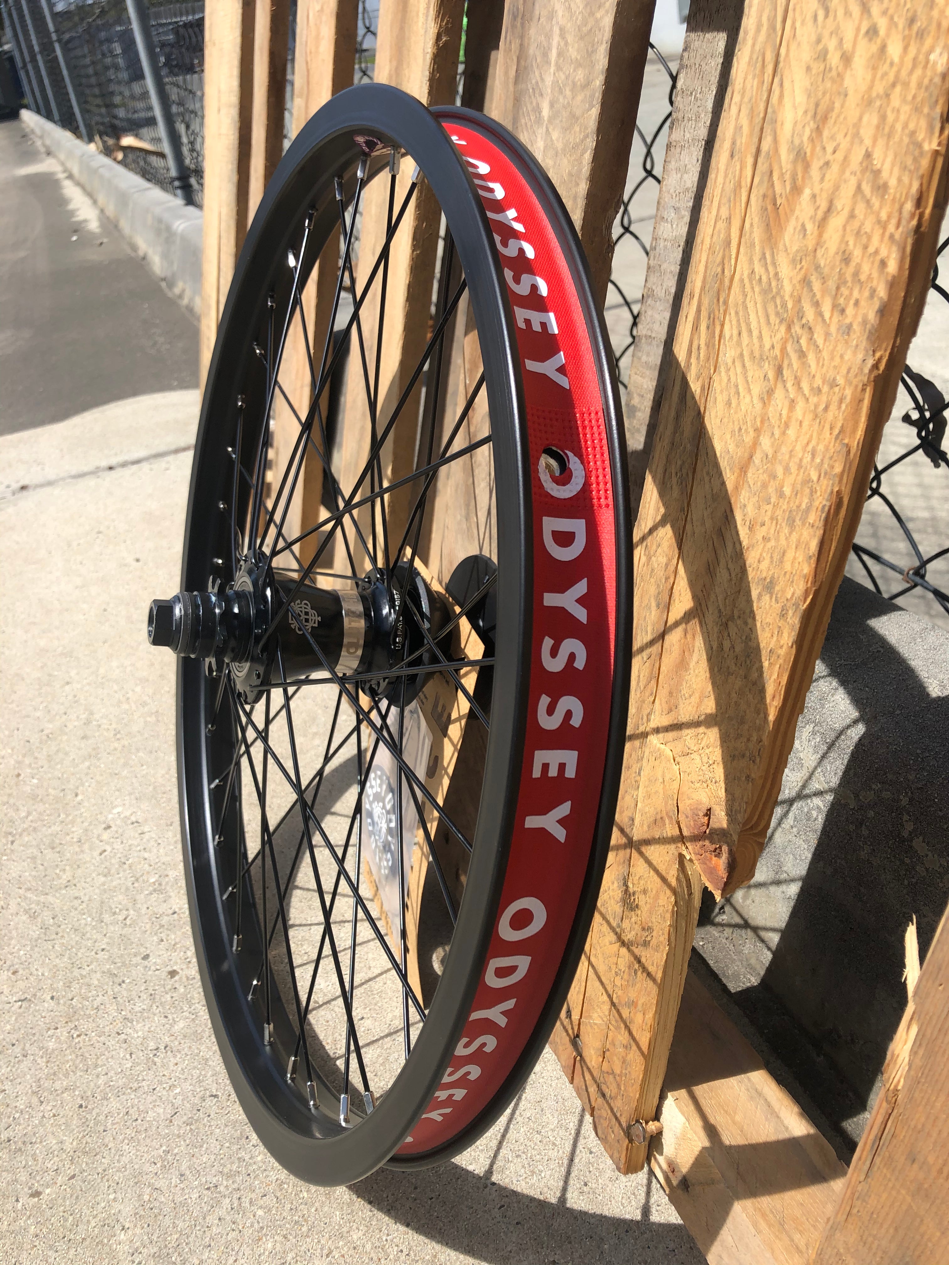 A rim with the Odyssey Quadrant X Clutch V2 Rear Wheel written on it.