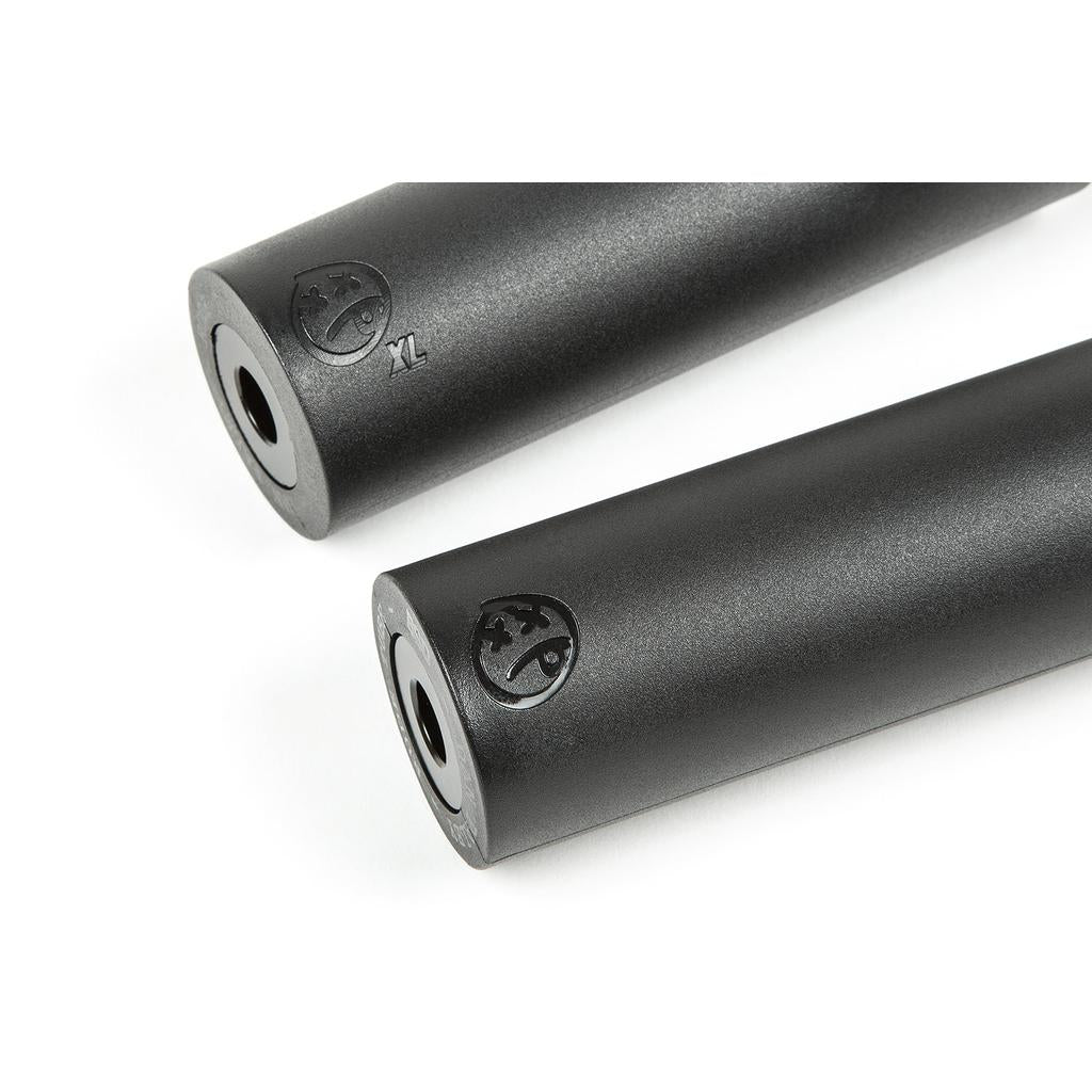 A black BSD Rude Tube XL Plastic Peg with a cylindrical shape, flat ends, an engraved Dan Paley signature logo, and a small central hole is shown on a white background.