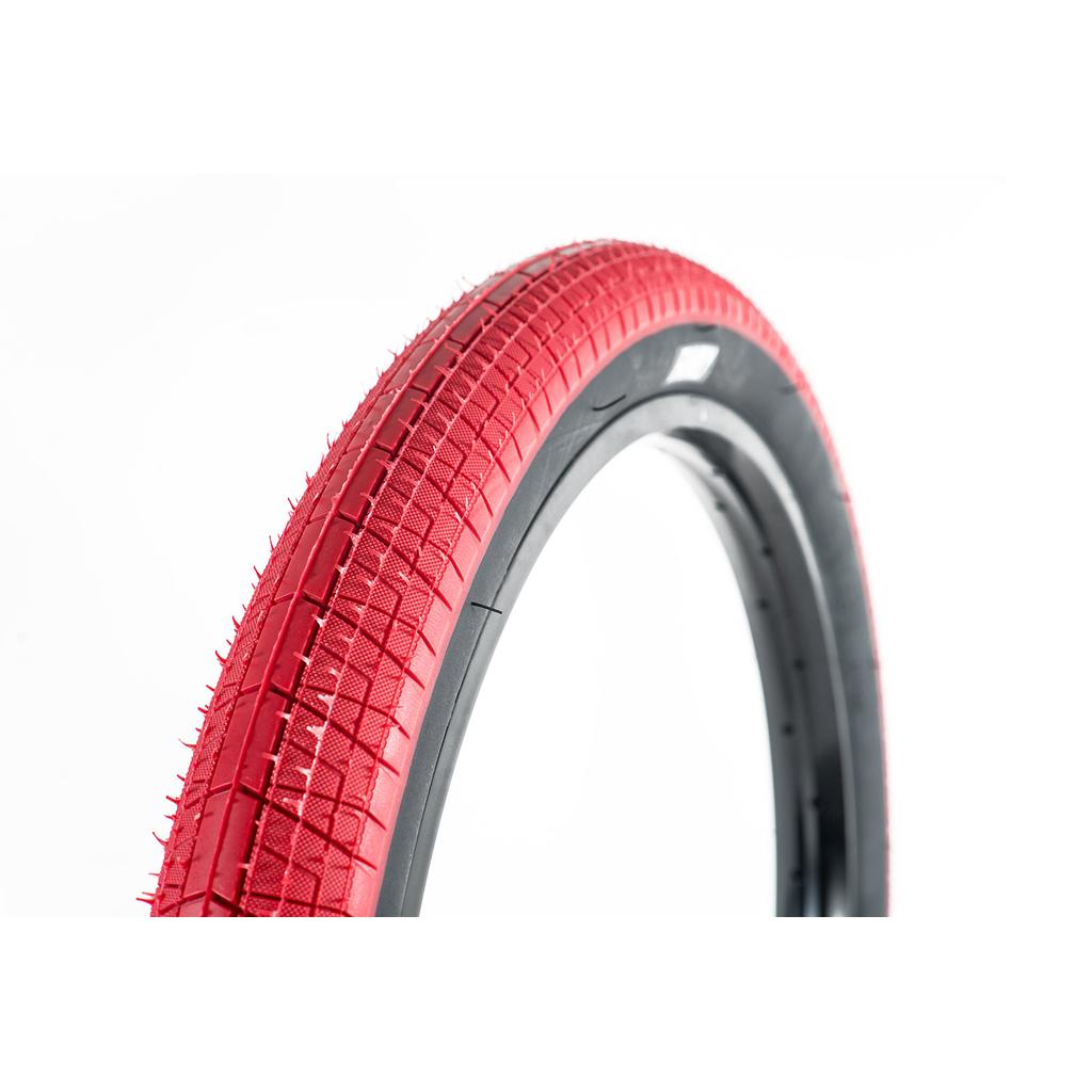 A close-up of the Family F603 16 Inch Tyre in red with a black inner edge, showcasing its tread pattern against a white background—ideal for riders looking for great value.