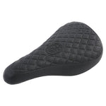 The Odyssey Aitken Pivotal Seat features a black, textured diamond-patterned surface and a round center logo—blending classic BMX style with Mike Aitken’s signature design.