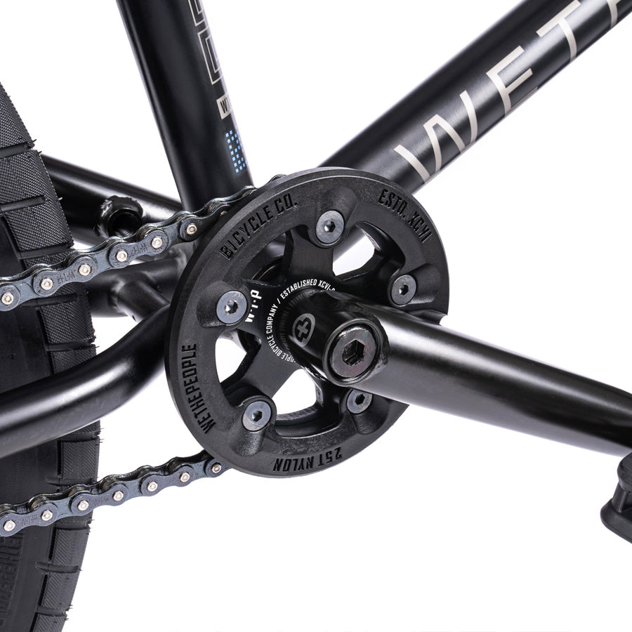 A close up of a Wethepeople Trust 20 Inch Freecoaster bike with a chain.