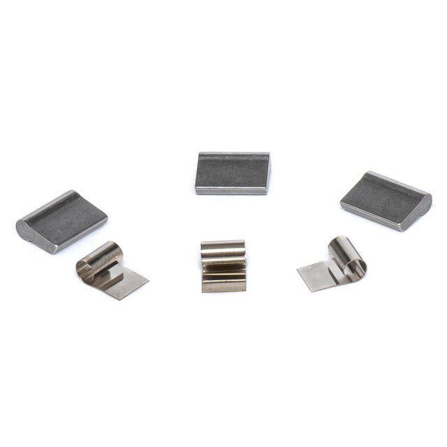 An assortment of metal pieces with different shapes and sizes, including a replacement pawl from the Eclat Shift Hub Pawl and Spring Kit.