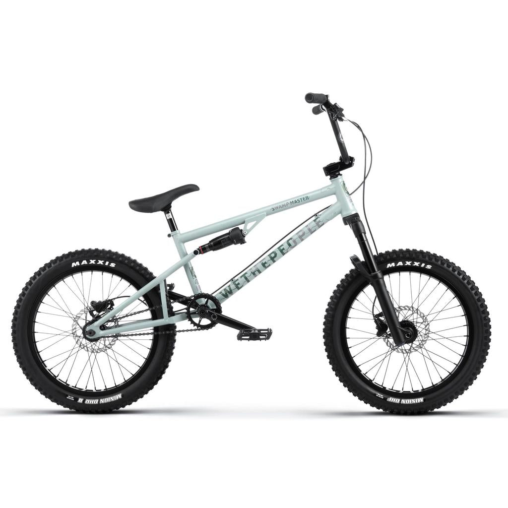 The Wethepeople Swampmaster 20 Inch Bike, featuring BMX components, thick Maxxis tires, a black seat, and disc brakes, is shown in profile against a white background.