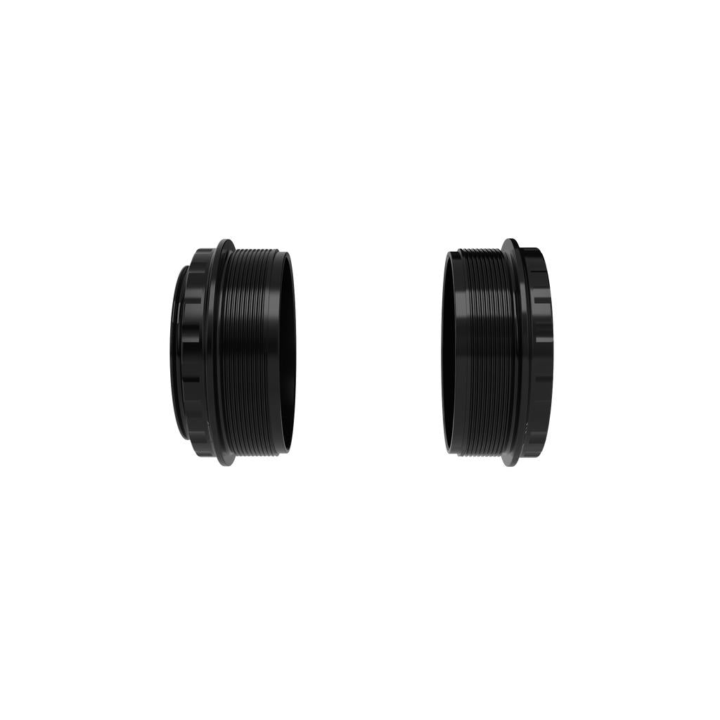 Two black, cylindrical threaded metal components—the Box ONE Bottom Bracket B52 35mm with Oversized Technology—are shown side by side against a white background, designed to enhance bike power transfer.