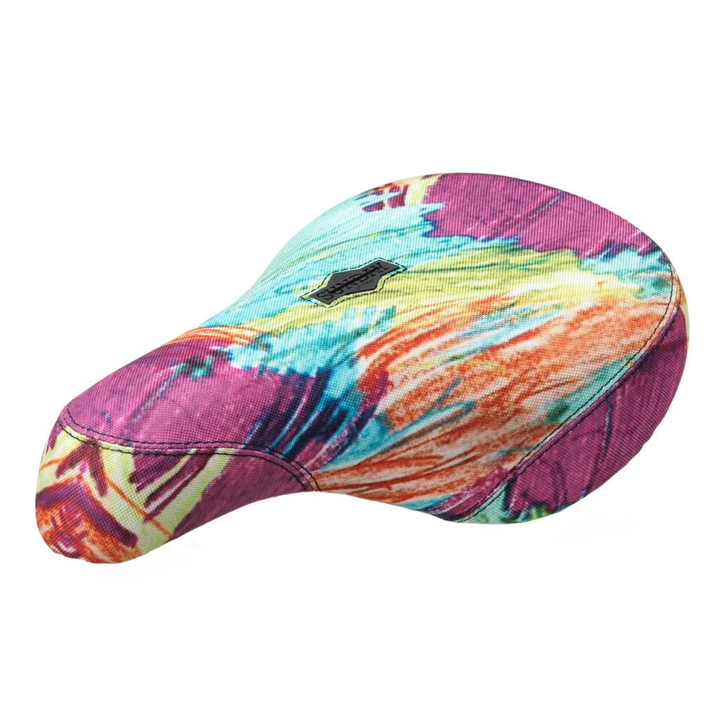 The Sunday Scribbles Pivotal Seat features a vibrant multicolored tie-dye cover and a small black patch on the front top, offering eye-catching style for standout builds. Pivotal only compatibility.