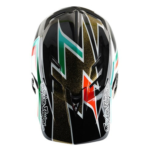 Experience exhilarating BMX rides with the TLD 25.1 D4 Carbon Helmet (MIPS), boasting a black and gold angular design pattern and "Troy Lee Designs" branding on the sides. This helmet delivers style and full frontal safety with advanced MIPS protection.