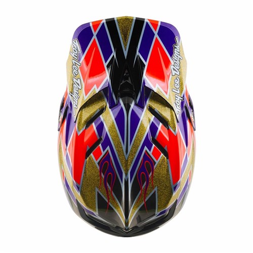 Top view of the TLD 26.2 D4 Carbon Full Face Helmet / MIPS Flush Violet, showcasing bold geometric patterns in purple, red, gold, and black with “Troy Lee Designs” text on both sides. This downhill helmet delivers standout style along with advanced Mips protection for enhanced safety.