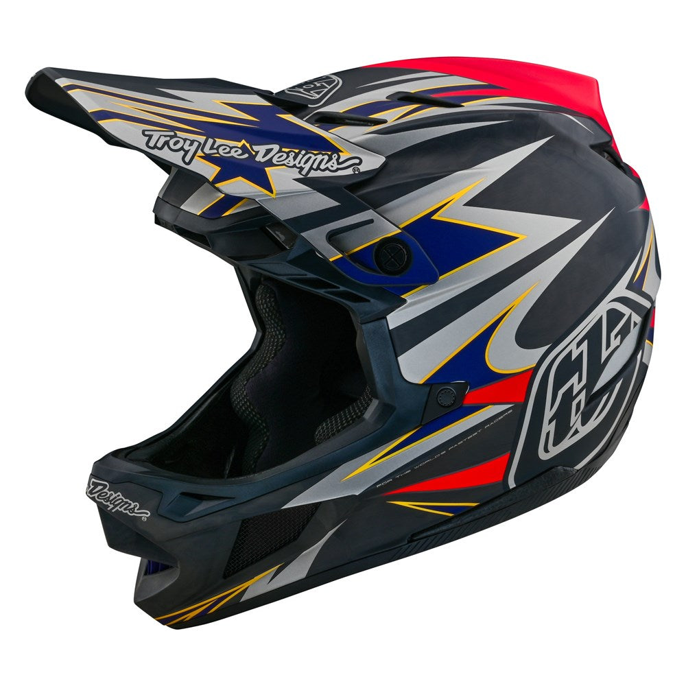A TLD D4 Carbon AS Helmet W/MIPS Inferno Grey with a red, blue, and yellow design.