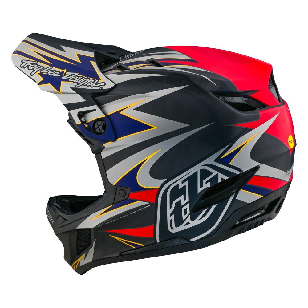 A TLD D4 Carbon AS Helmet W/MIPS Inferno Grey with a red, blue, and black design featuring the MIPS Brain Protection System.