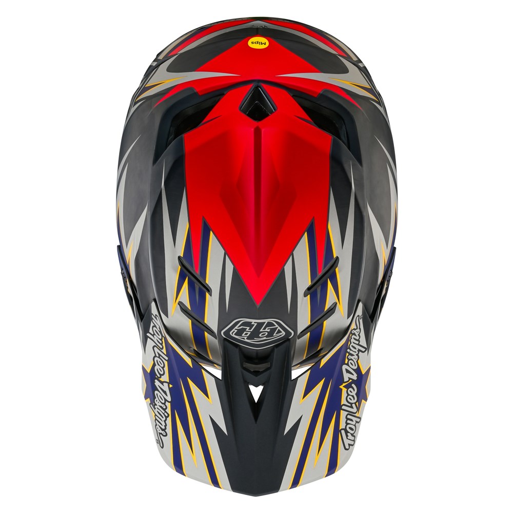 A TLD D4 Carbon AS Helmet W/MIPS Inferno Grey with a red and blue design, featuring TeXtreme® Spread Tow carbon fiber reinforcements.
