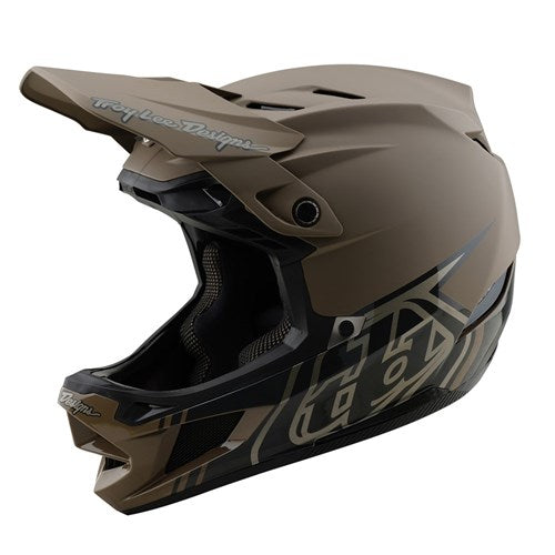 The TLD 25.1 D4 Composite Helmet (MIPS) in Stealth Caper is a matte brown full-face helmet with geometric patterns, ventilation openings, and an integrated visor; designed for safety on downhill adventures with MIPS protection.