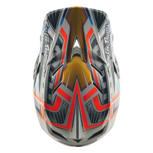 A top-down view of the TLD 25.2 D4 Composite Helmet MIPS Lowrider Grey reveals its glossy geometric design, with "Troy Lee Designs" text on each side and bold red, gold, gray, and black BMX helmet colors.