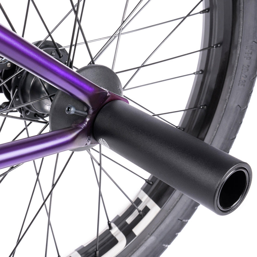 A Wethepeople Trust 20 Inch Freecoaster Bike with purple pedals.