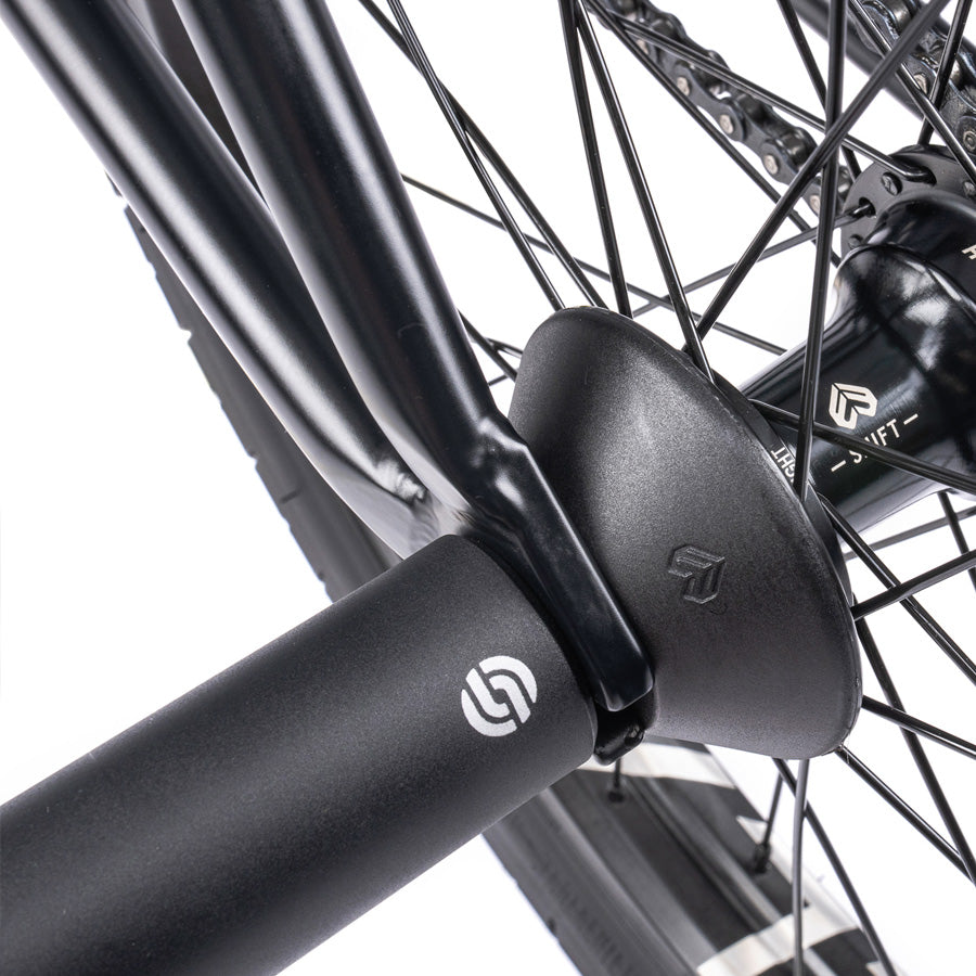 A close up of a black bicycle featuring the Wethepeople Trust 20 Inch Cassette Bike.