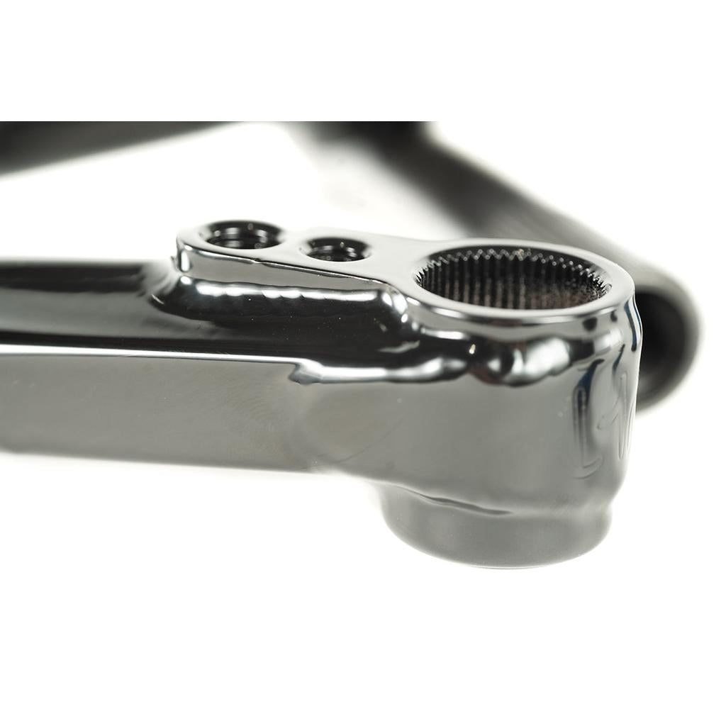 Close-up of a shiny black metal BMX frame part with holes and mesh, perfect for pairing with Cult Hawk V2 Cranks and 22mm chromoly cranks in your BMX build.