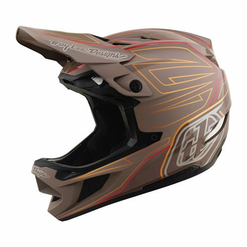 The TLD D4 Polyacrylite Helmet / Shadow Pro Timber is a brown full-face mountain bike helmet with striking red and orange accents, a large visor, chin guard, and “Troy Lee Designs” logo on both the side and visor. Built with a robust Polyacrylite shell, it features advanced Mips brain protection for enhanced safety.