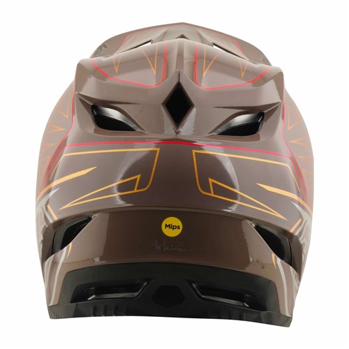 Front view of the TLD D4 Polyacrylite Helmet / Shadow Pro Timber, a brown full-face mountain bike helmet featuring red and yellow geometric patterns, black vents, and a yellow Mips brain protection sticker on the lower front. The durable Polyacrylite shell ensures both safety and style for your next ride.
