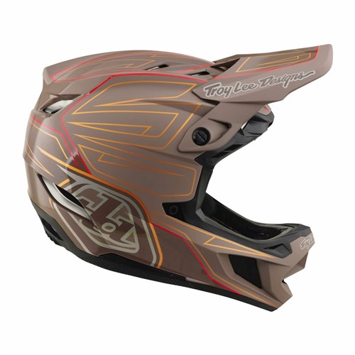 Experience ultimate protection and style on your mountain biking adventures with the TLD D4 Polyacrylite Helmet / Shadow Pro Timber. This matte brown full-face helmet features striking red and gold accents, a large visor, and the iconic “Troy Lee Designs” logo on the side. Equipped with the advanced Mips brain protection system for enhanced safety.
