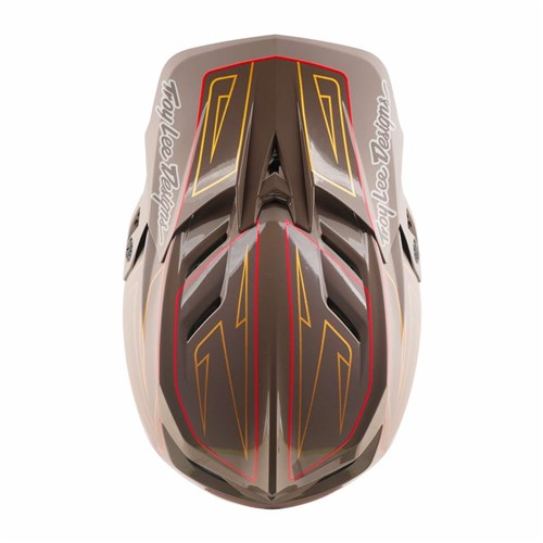 Top view of the TLD D4 Polyacrylite Helmet / Shadow Pro Timber, a brown full-face mountain bike helmet with gold, red, and yellow geometric designs and “Troy Lee Designs” logos on the sides. Features a Polyacrylite shell and Mips brain protection for enhanced safety.
