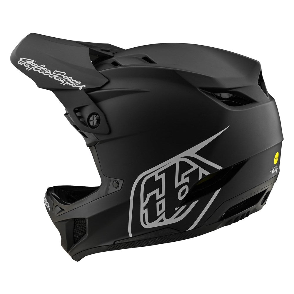 The TLD D4 AS Polyacrylite Helmet W/MIPS Stealth Black is a matte black full-face helmet with a visor, ventilation openings, and a bold white side logo.
