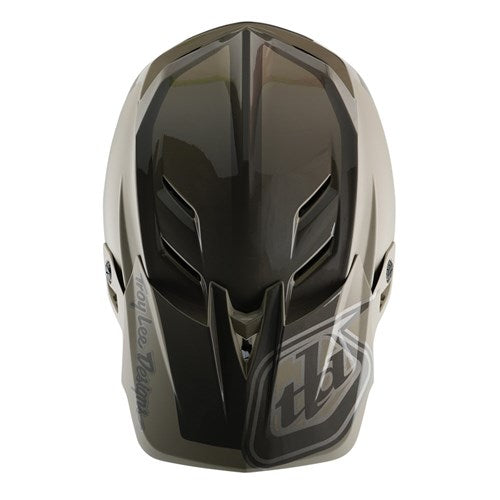 The TLD D4 Polyacrylite Helmet (MIPS) / Shadow Timber offers a top view of a dark, glossy full-face motocross helmet with ventilation slits and an angular design, enhanced with Mips brain protection for added safety.