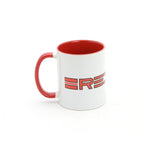 The Redline 80's Logo Coffee Mug is a white 12oz mug with a red handle and interior, showcasing a striking red and black "ERE" design—ideal for enjoying your morning coffee.