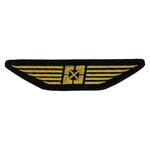 The Fit Bike Co Wings Embroidered Patch is a black patch with gold wings and a central star, featuring a satin border and heat seal backing—perfect as an aviation or pilot insignia.