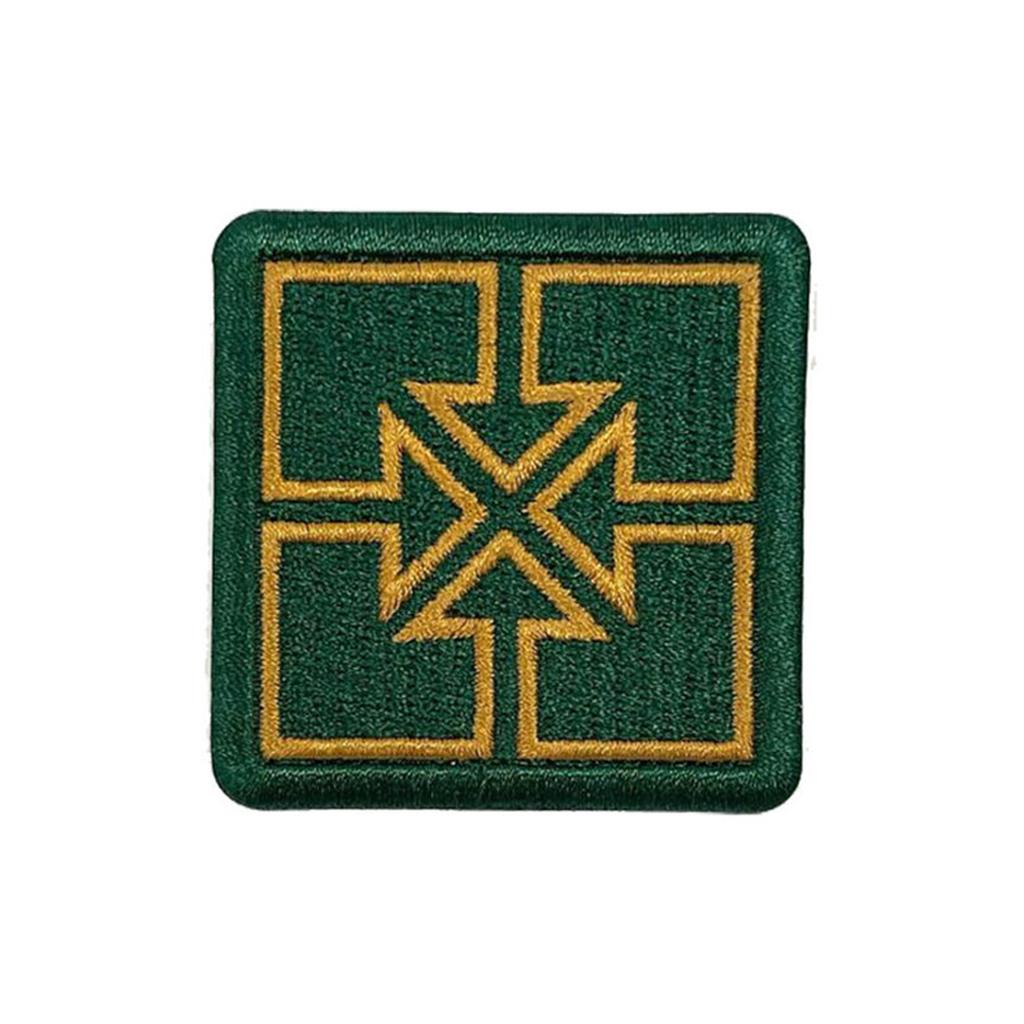 The Fit Bike Co Key Embroided Patch is a green square patch with a satin border, featuring four gold-outlined rectangles and crossed arrows forming an X shape in the center.