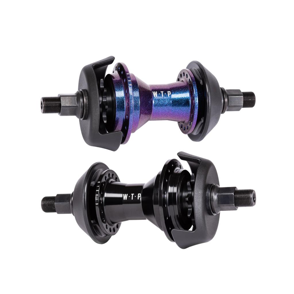 The Wethepeople Hybrid Hub comes in black and iridescent blue-purple with robust black axle nuts, "W-T-P" branding, and a patented magnetic pawl retention system for enhanced performance.