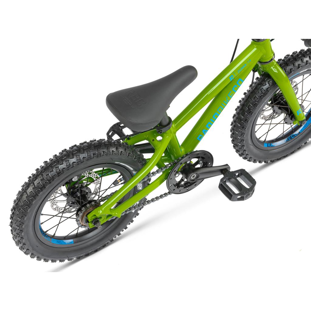 The Radio Zuma 14 Inch Bike is shown from above, featuring the seat, pedals, rear wheel with knobby tires, and disc brakes—a lightweight bike designed for young riders' adventures.
