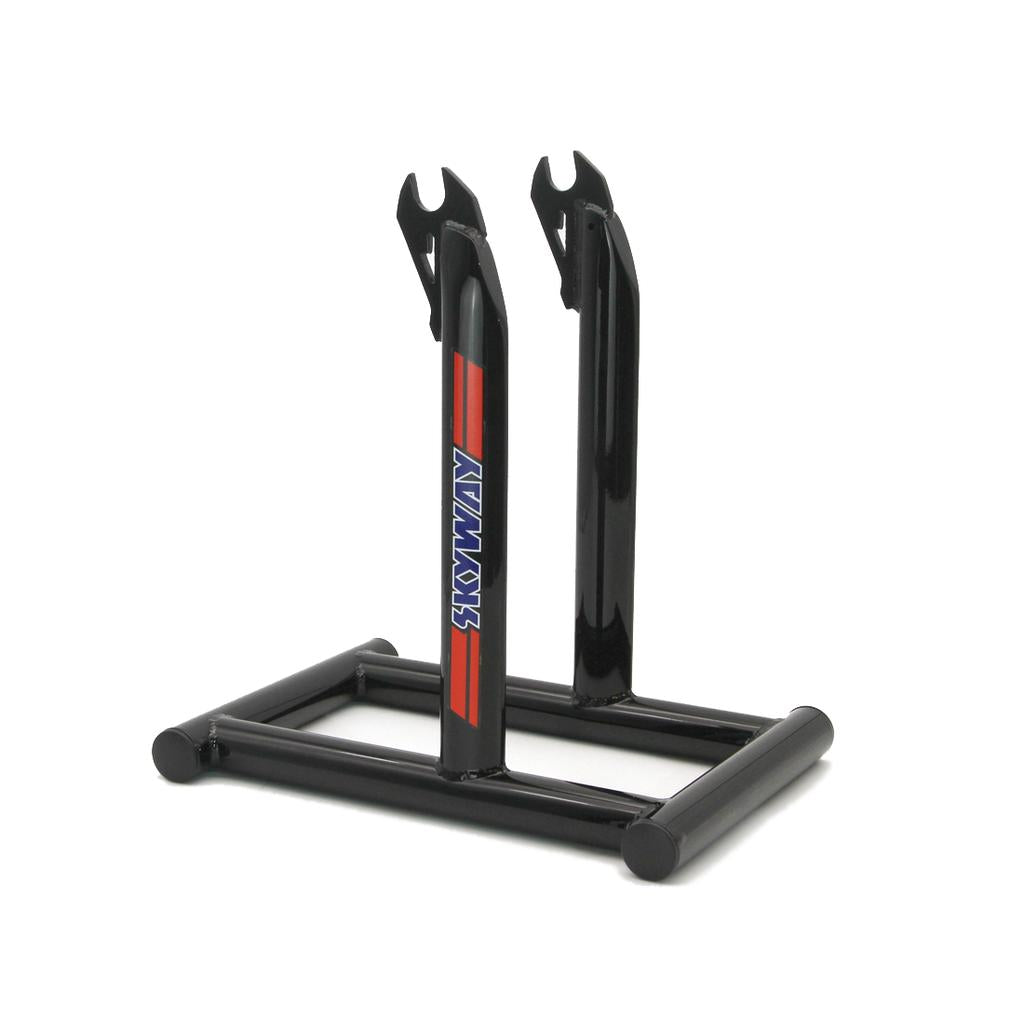 The Skyway Stolz Stand is a black metal BMX bike stand with two upright arms and a rectangular base, featuring a "SKYWAY" logo—perfect for displaying your Skyway TA Replica.