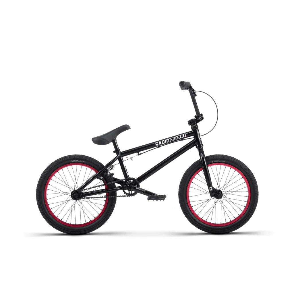 Radio Saiko 18 Inch Bike, featuring red-rimmed Salt Tracer tyres and "RADIOBIKECO" branding, shown side-on against a white background. A stylish and high-performance kids BMX bike perfect for young riders.