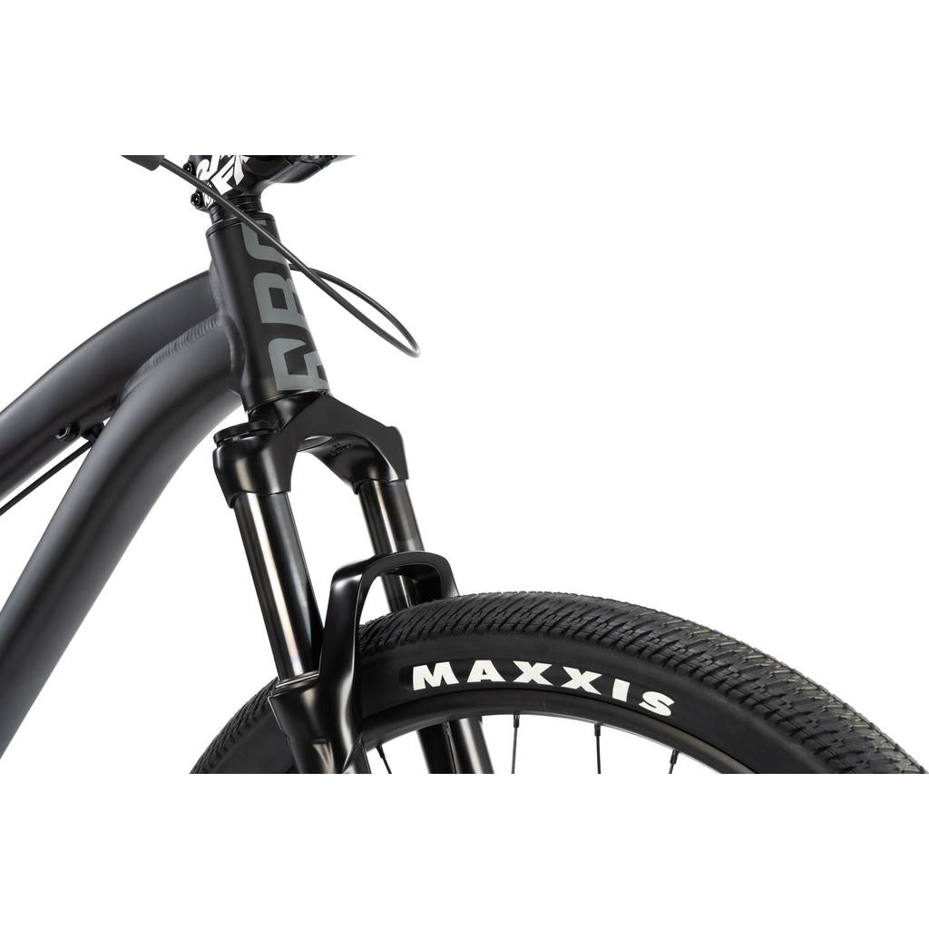 Close-up of the Radio 26 Inch Griffin Pro Bike's black front suspension fork and Maxxis tire, highlighting its alloy frame. Shot against a white background, this bike exemplifies quality and durability.