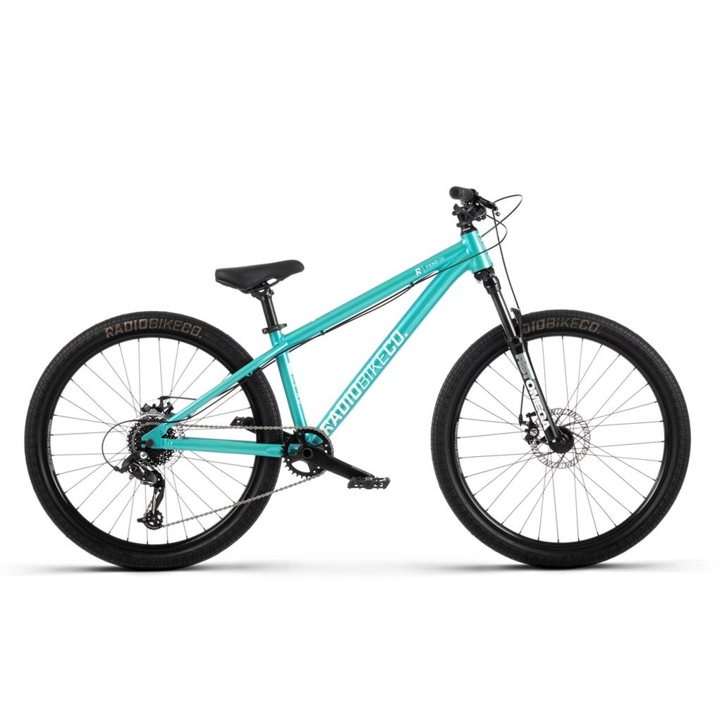 A Radio Fiend 26 Inch Bike in turquoise, featuring a 6061-T6 alloy frame, black wheels, disc brakes, and a straight handlebar, is shown in profile on a white background.