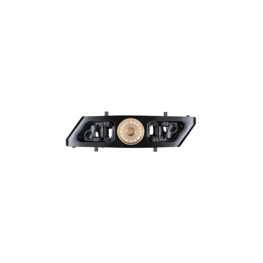 A black Odyssey Trailmix Sealed Pedal with a central gold circular detail, shown side-on against a white background; features a durable sealed bearing design.