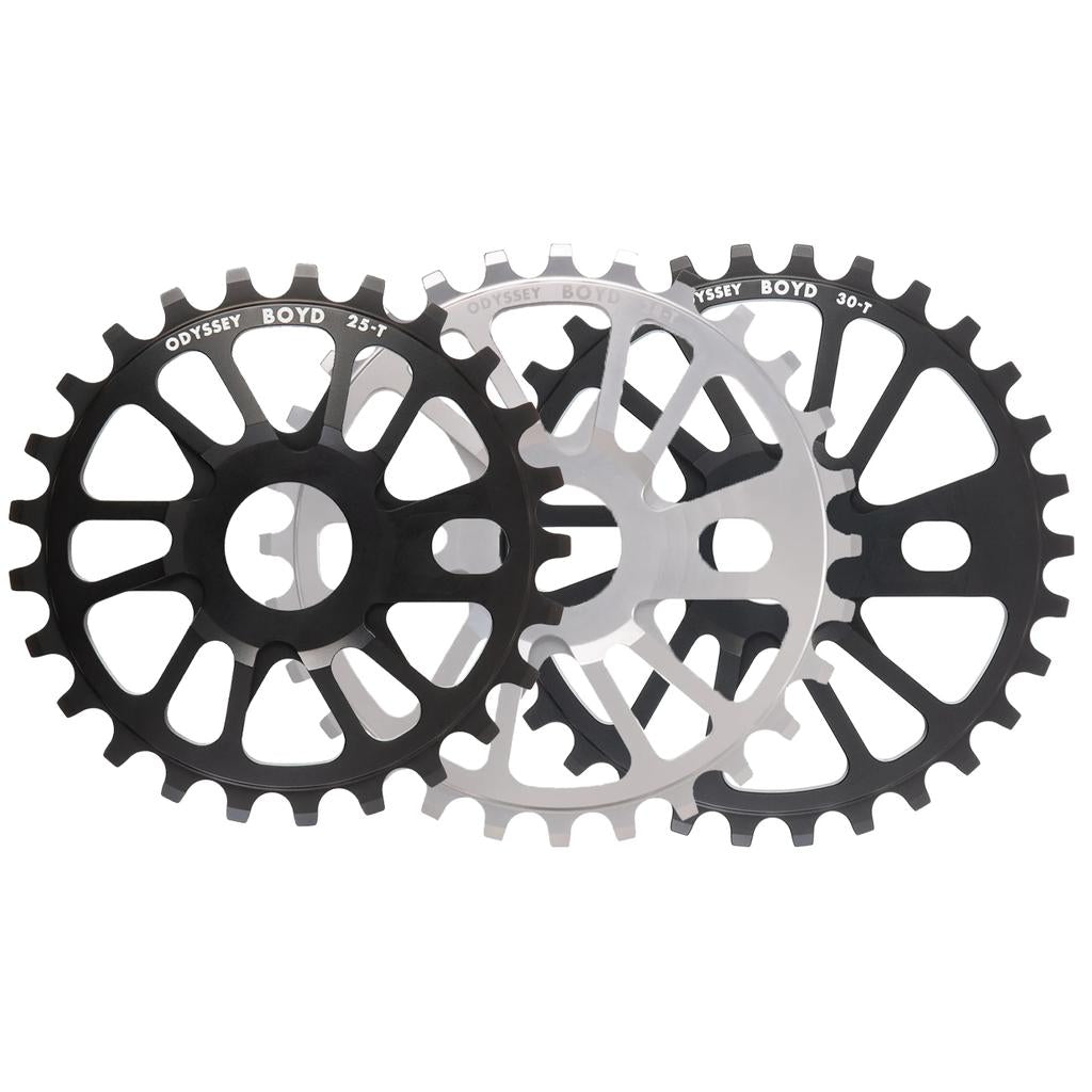Three overlapping Odyssey Boyd Sprockets, shown in black and silver finishes with different tooth counts, are featured. A top pick for Odyssey BMX fans, this sprocket is also available at LUXBMX as the Boyd Hilder model.