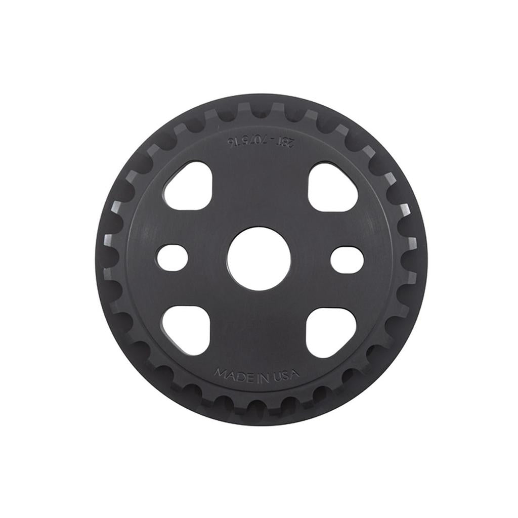 The S&M X-Man Guard Sprocket is a circular sprocket, precisely CNC machined from durable 7075 T6 Aluminum, featuring evenly spaced teeth around its edge, multiple holes in its center, and proudly marked with "Made in USA.