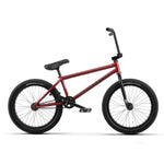 The Wethepeople Justice 20 Inch Bike features a red frame with black handlebars, seat, and tires, displayed in profile on a white background—perfect for adrenaline-fueled city rides.