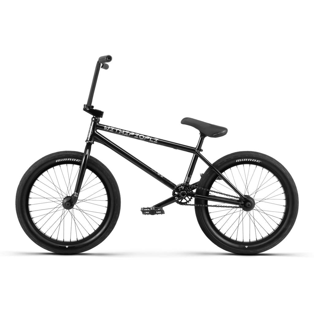 The Wethepeople Envy 20 Inch Bike, a black BMX with thick tires, straight top tube, high handlebars, padded seat, and durable Chromoly frame, is shown in a side profile against a white background.