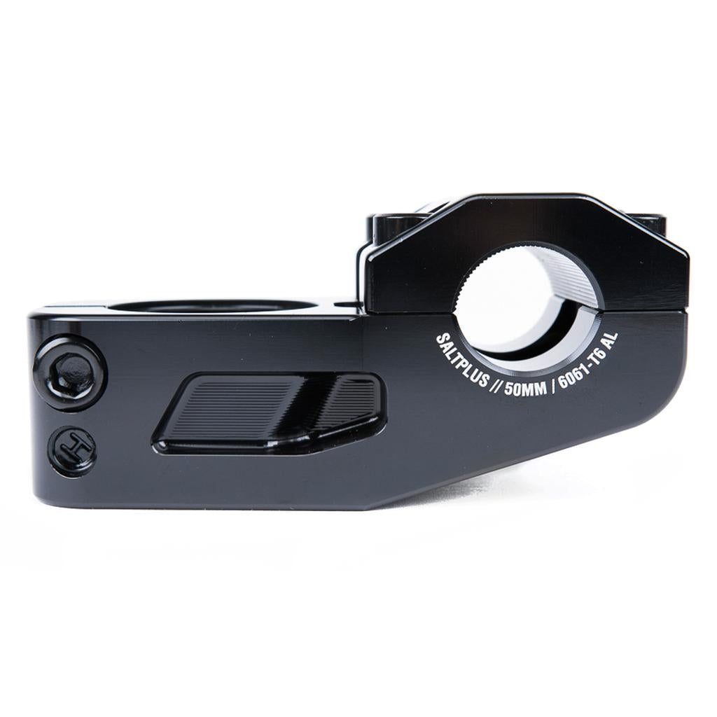 A close-up of the Salt Plus Manta Top Load Stem, made from CNC 6061-T6 Alloy and marked "SALTPLUS / 50MM," shows mounting holes, textured grip zones, and Shark Tooth Clamping for extra security.
