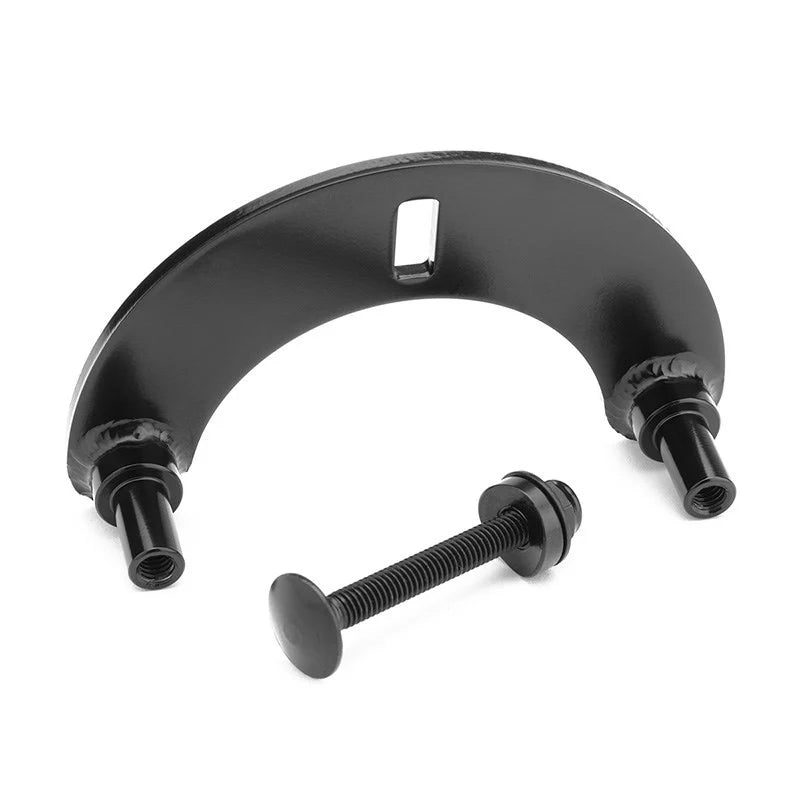 The Mission 990 Brake Plate is a black metal adaptor bracket with a curved design and centered slot, plus separate bolt and washer—perfect for use with 990 brakes.