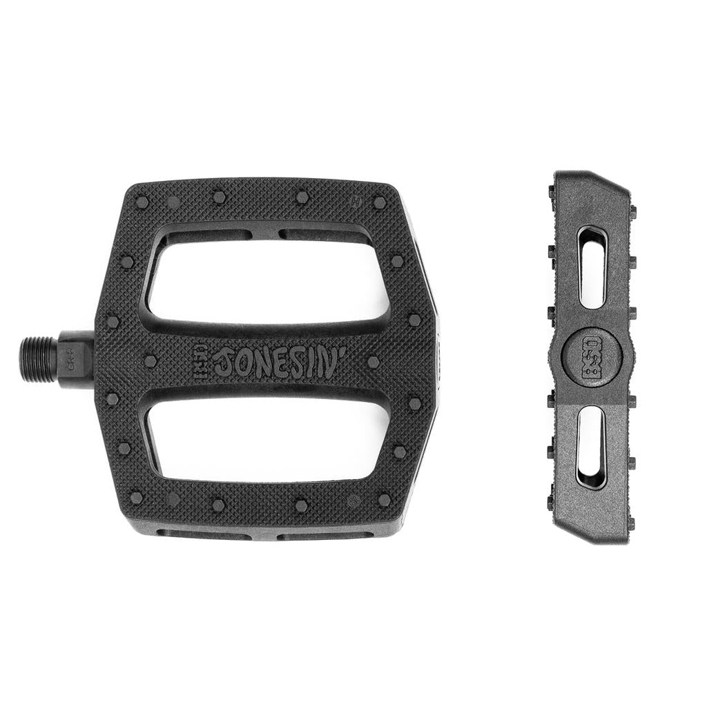 BSD Jonesin Pedals in black plastic, marked "JONESIN," are shown from top and side views on a white background. They feature a dual concave design for improved grip.