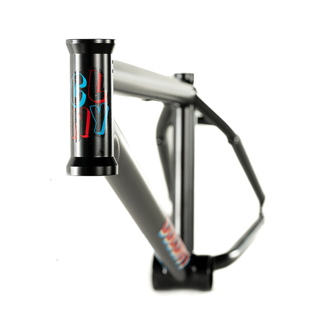 A black bike frame with a blue and red logo on it, the Colony Enishi Flatland Frame (Kio Hayakawa Signature) is Kio Hayakawa's signature model designed specifically for flatland riders.
